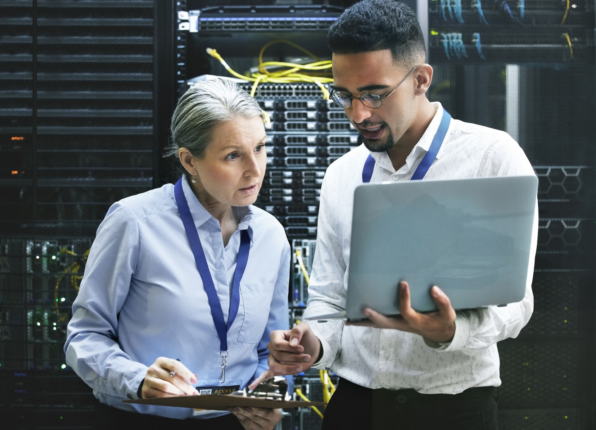 Shot of two technicians working together in a server room